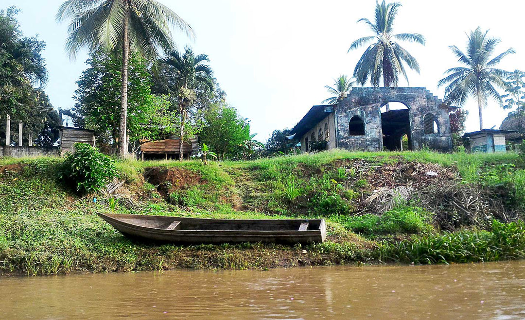 Wounaan guide steering canoe along the Darién river in Panama, en route to remote artisan village