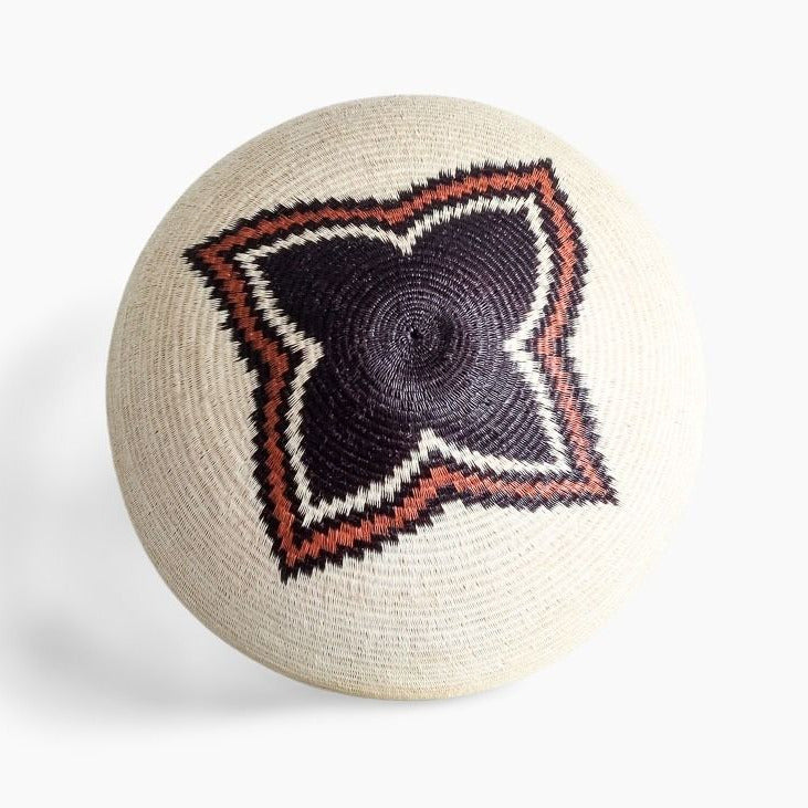 Round woven basket with a geometric pattern on a white background