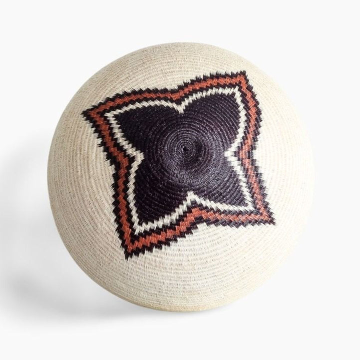 Round woven basket with a geometric pattern on a white background