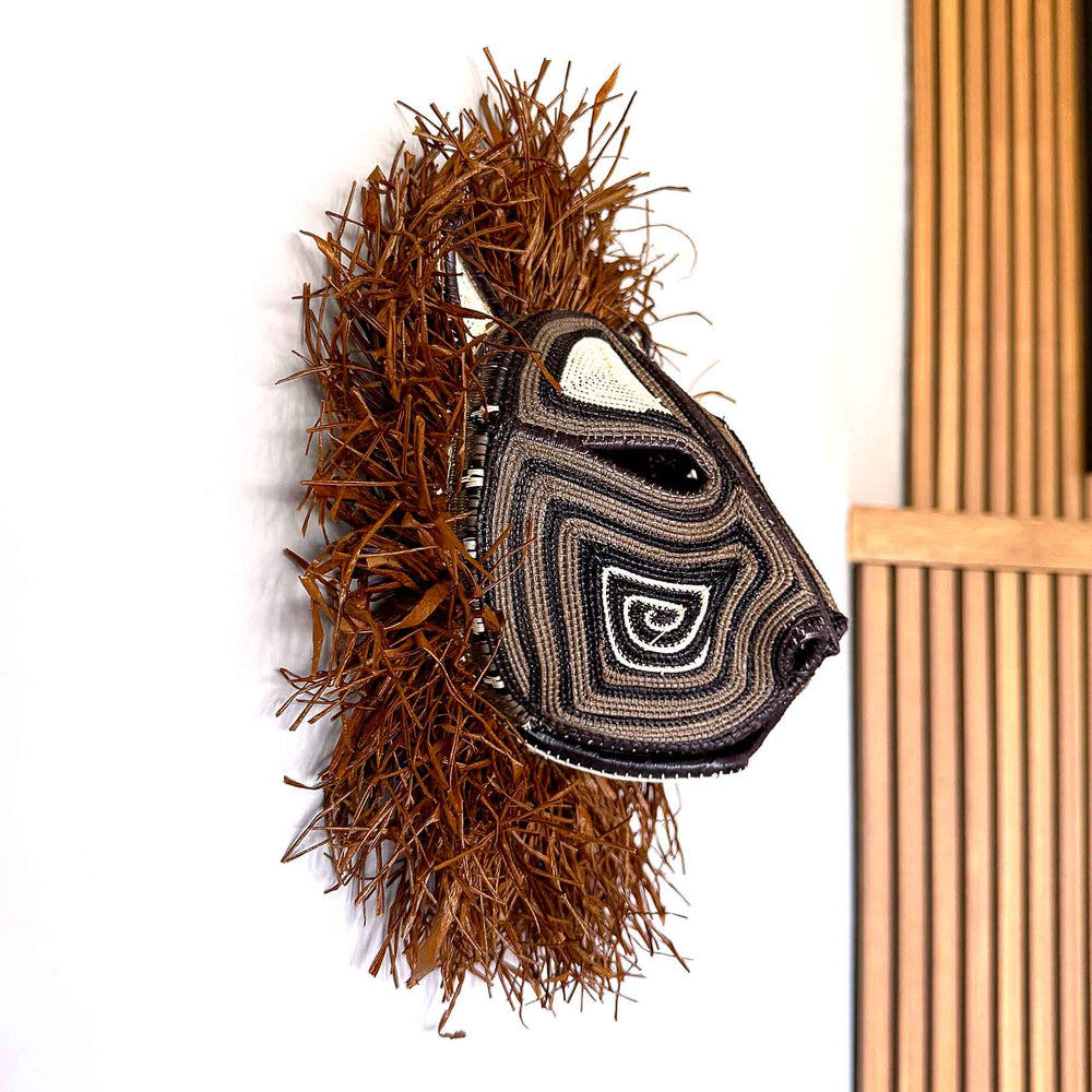 Wild Mane Cat Mask side view, 12" woven art by Embera weaver Felicinda Guaynora, Panama palm fiber feline mask with concentric designs and shaggy mane.