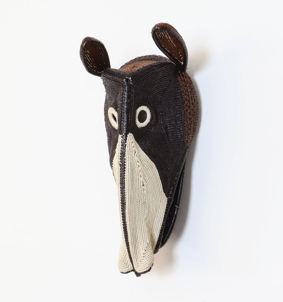Forest Dog Mask, 10" woven art by Embera weaver Felicinda Guaynora, Panama palm fiber dog mask in black, ivory, and brown with elongated muzzle and upright ears.