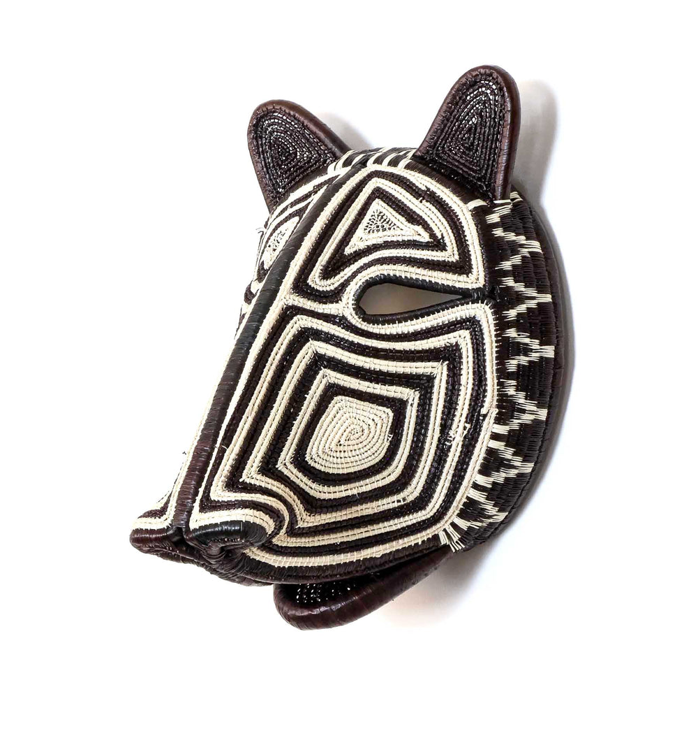 Side angle of Embera woven cat mask in black and ivory fibers