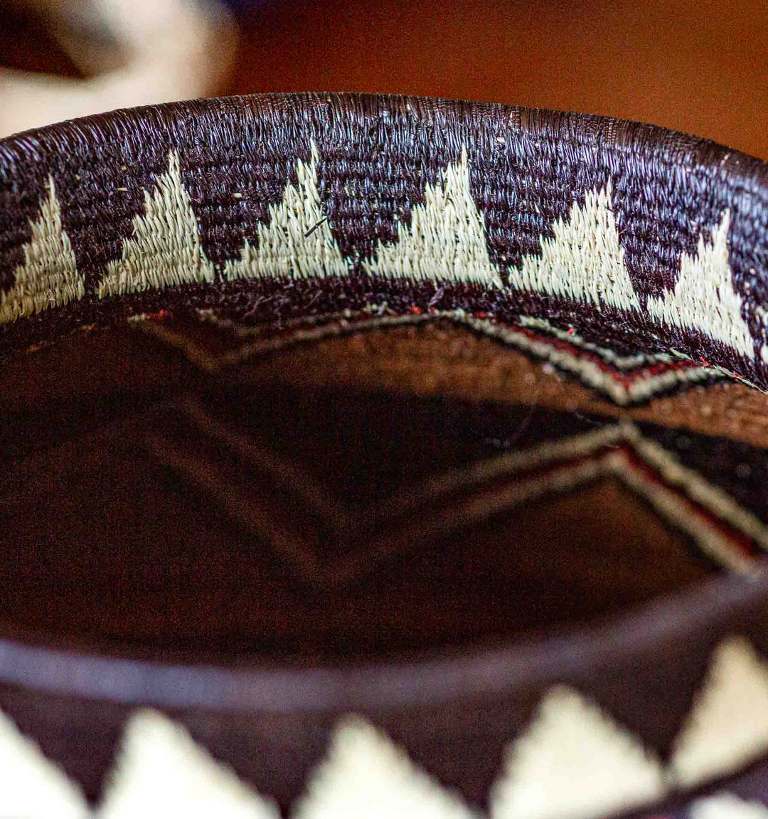 Detail of zigzag pattern on Ember Sunburst Wounaan basket in earthy tones