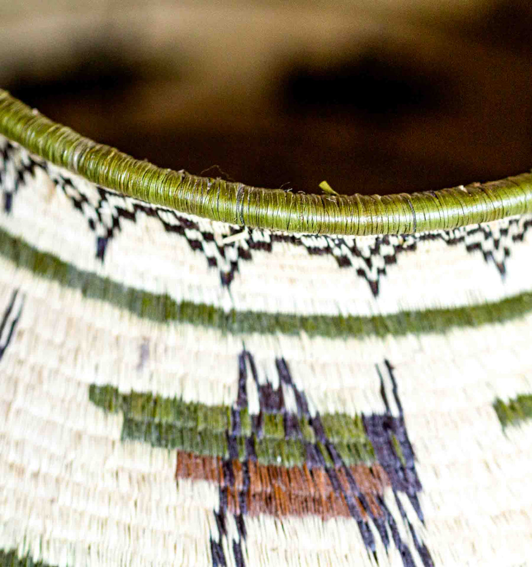 Close-up of rim detail with green fiber edging on Wounaan basket.
