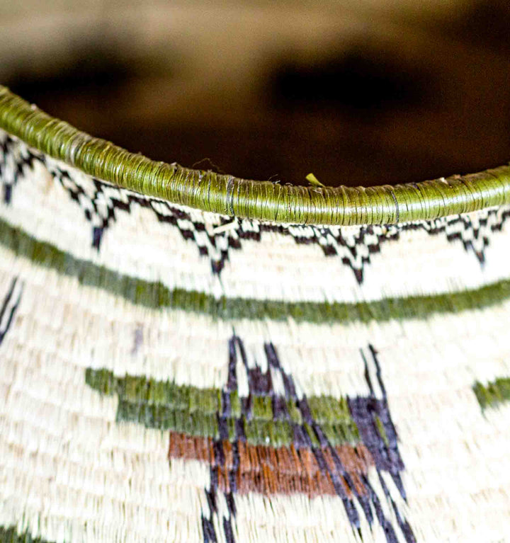 Close-up of rim detail with green fiber edging on Wounaan basket.
