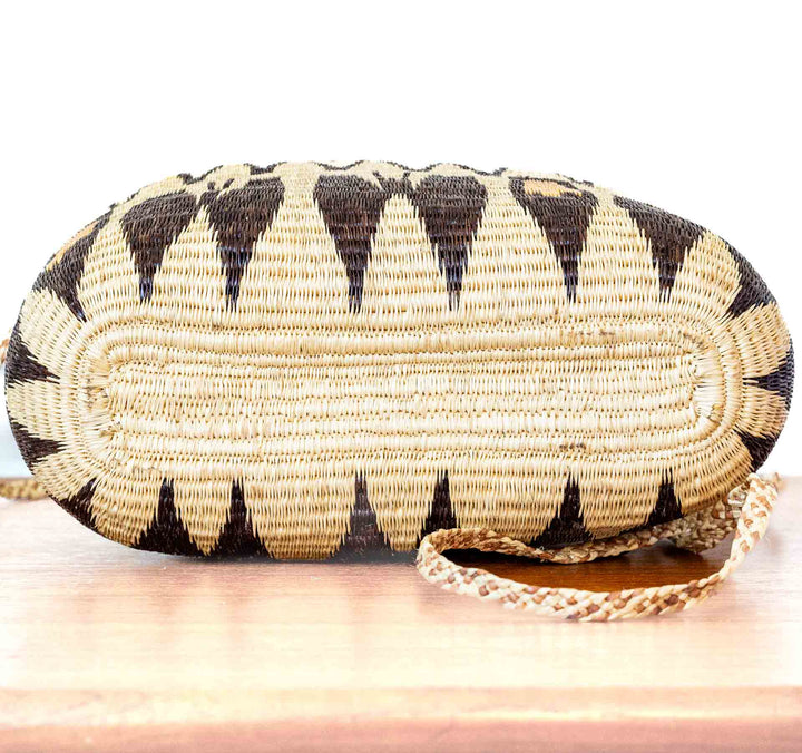 Side view of golden and brown geometric Wounaan basket purse