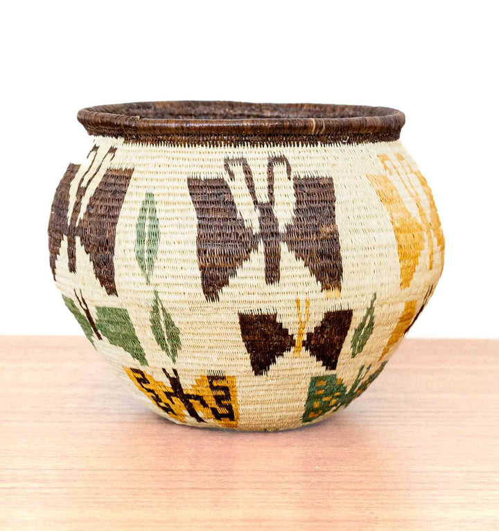 Side view of butterfly basket with brown, yellow, and green butterfly designs