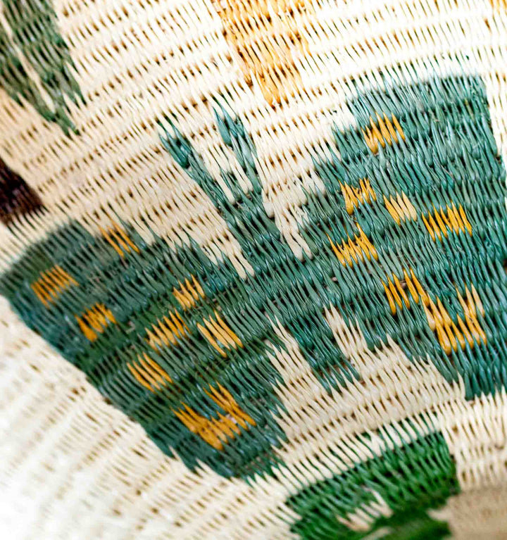 Close-up of butterfly motif in green and yellow on Panama Wounaan basket