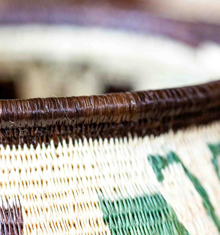 Detail of dark brown rim on handwoven butterfly basket