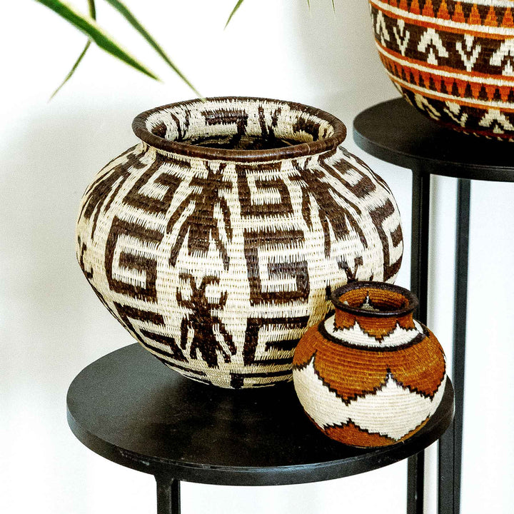 Large Wounaan basket featuring insect figures and geometric labyrinths.