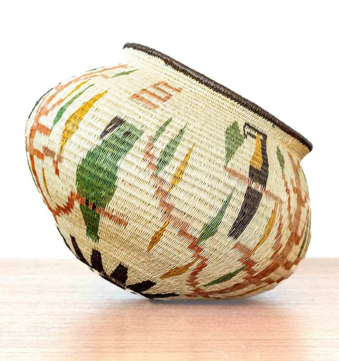 Wounaan basket highlighting multiple toucan and leaf motifs in natural dyes.