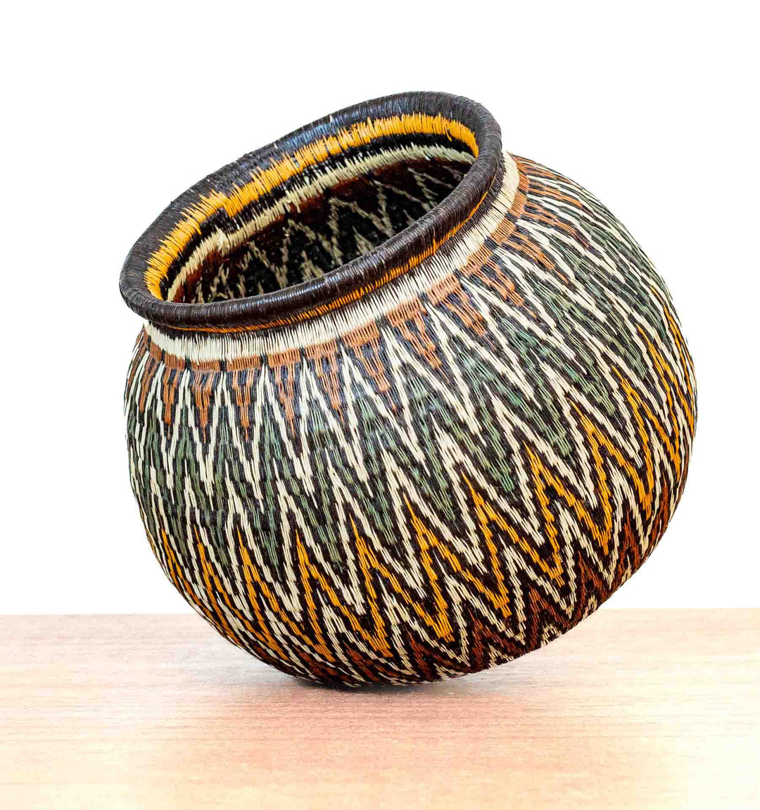Angled view of Rainforest Chevron Wounaan Basket showing bold zigzag motifs.