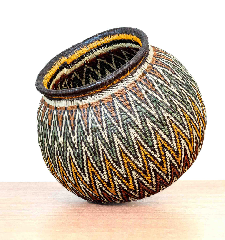 Angled view of Rainforest Chevron Wounaan Basket showing bold zigzag motifs.