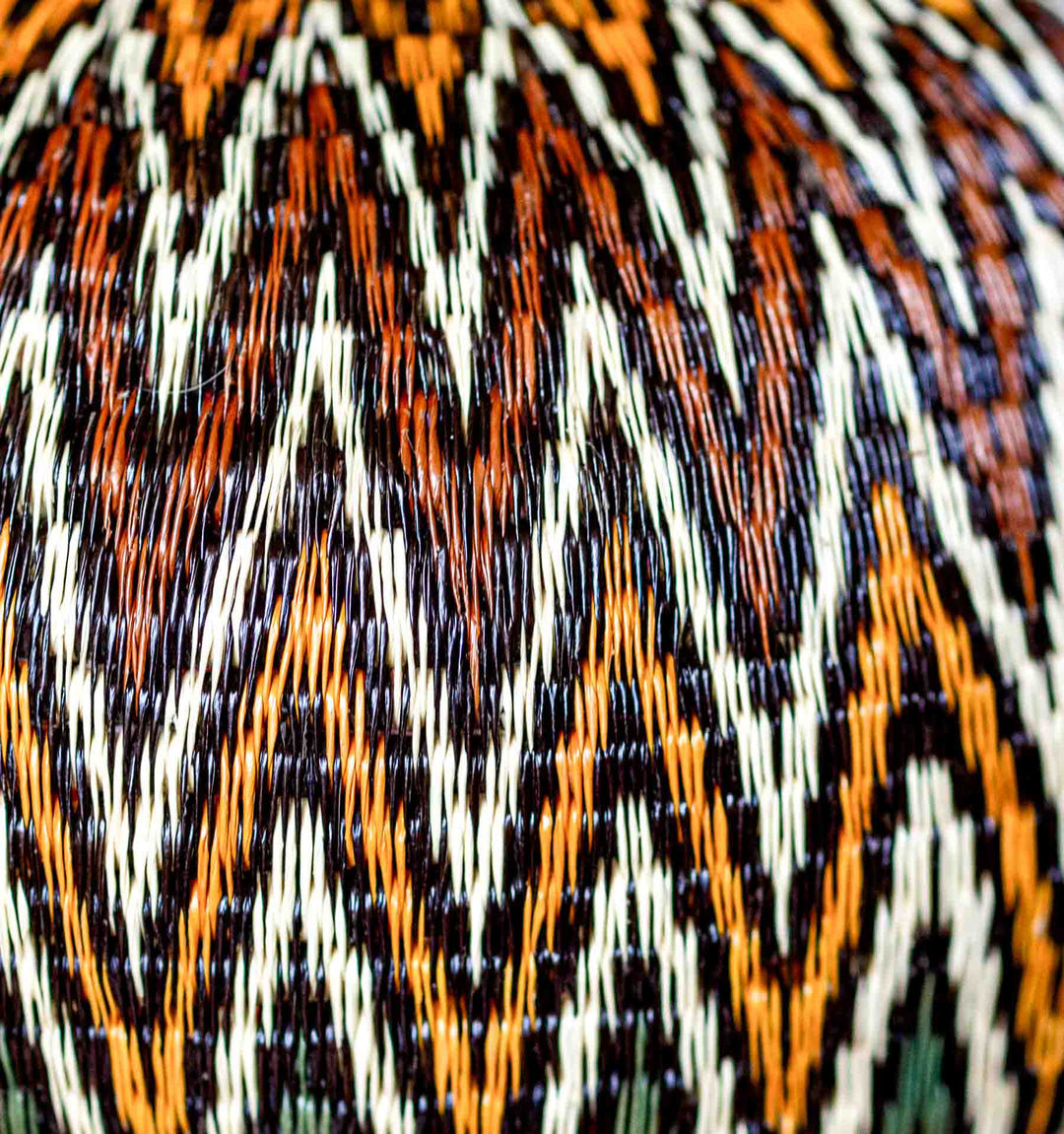 Close-up detail of fine weaving on Rainforest Chevron Wounaan Basket in gold, cream, and green.
