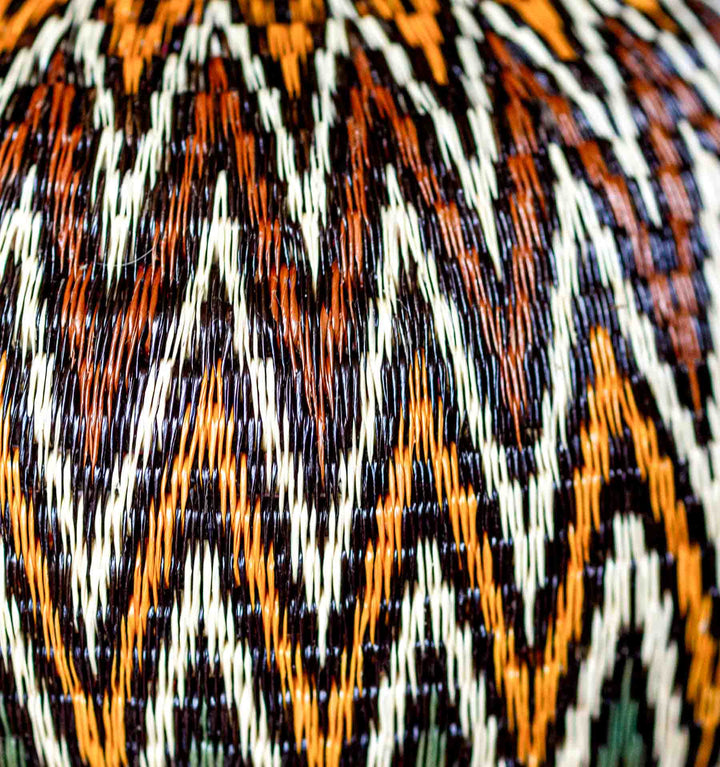 Close-up detail of fine weaving on Rainforest Chevron Wounaan Basket in gold, cream, and green.