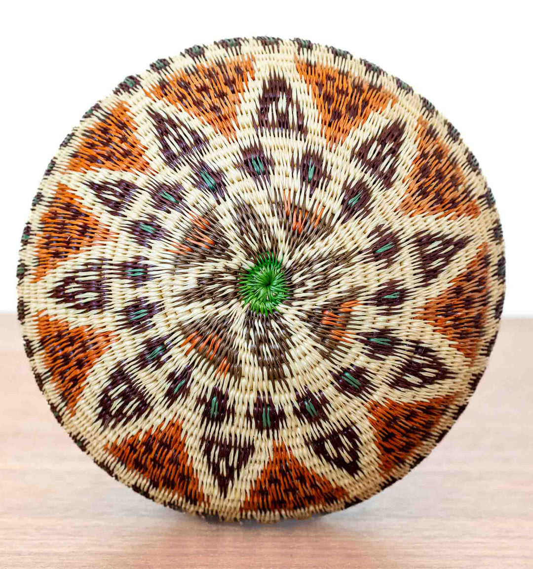 Bottom view of Ember Glow Wounaan Basket with green-centered starburst pattern