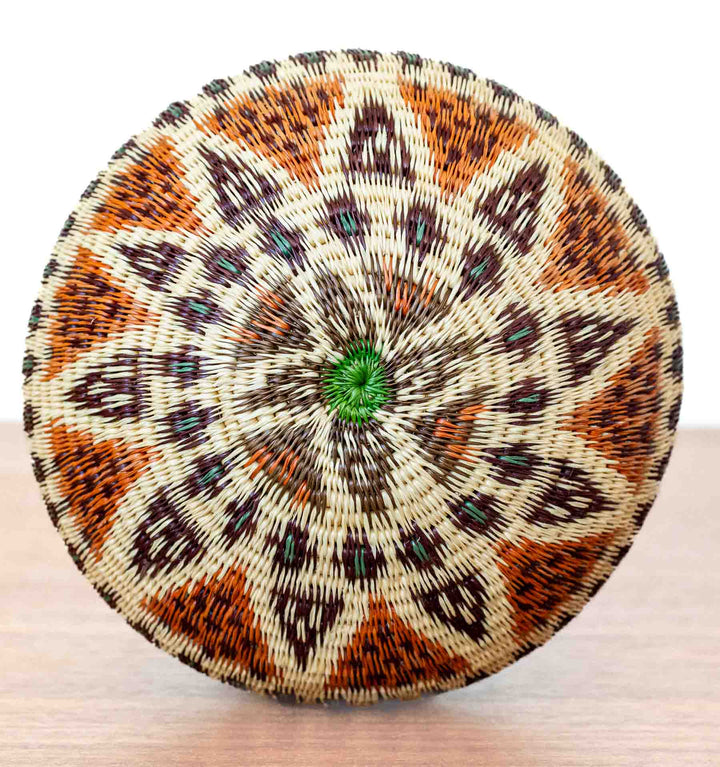 Bottom view of Ember Glow Wounaan Basket with green-centered starburst pattern