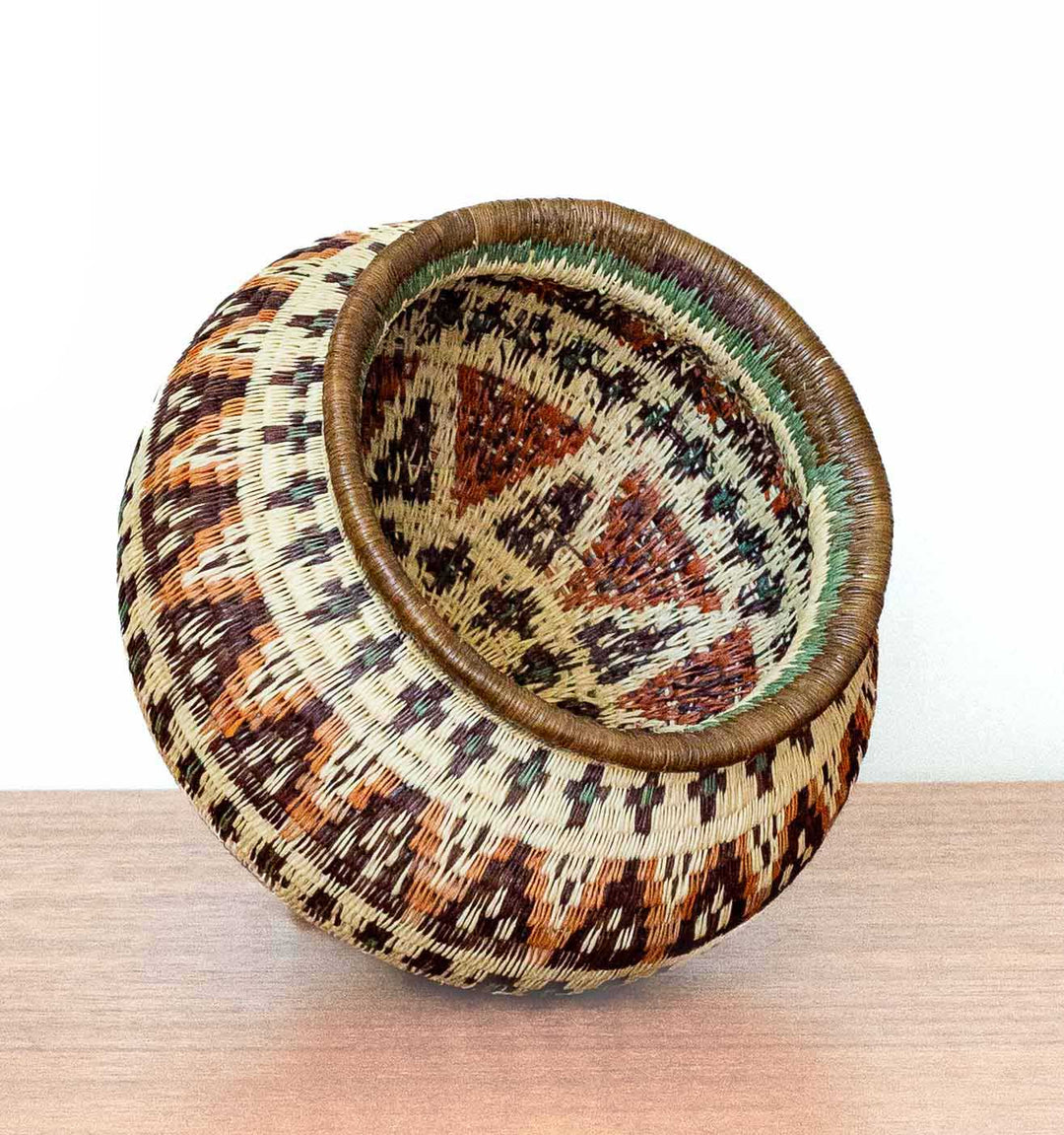 Ember Glow Wounaan Basket tilted to display chevron motifs and intricate stitching