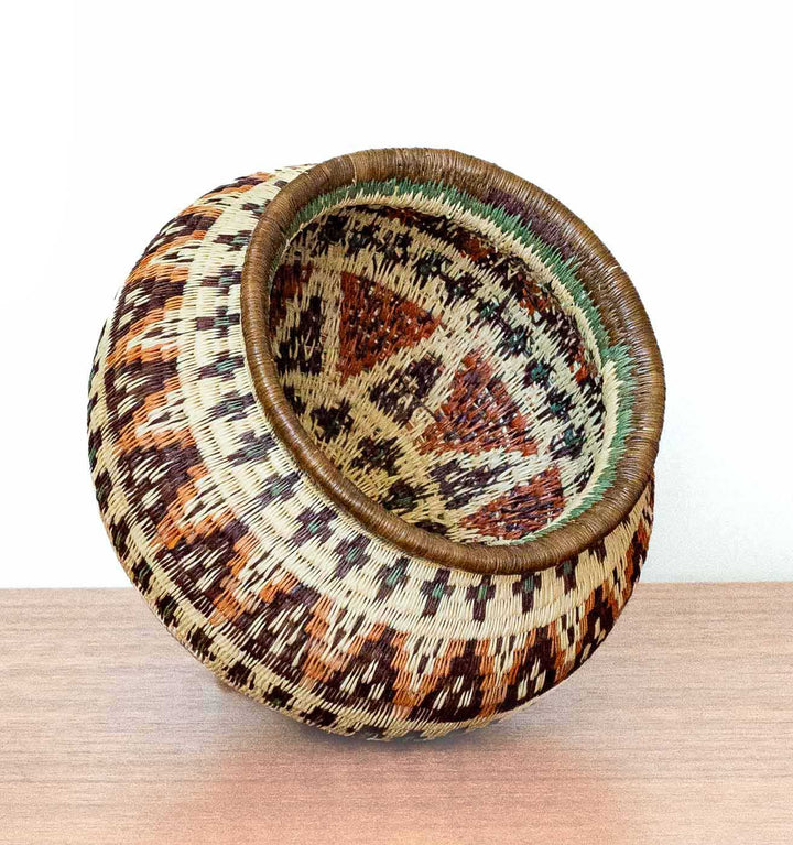 Ember Glow Wounaan Basket tilted to display chevron motifs and intricate stitching