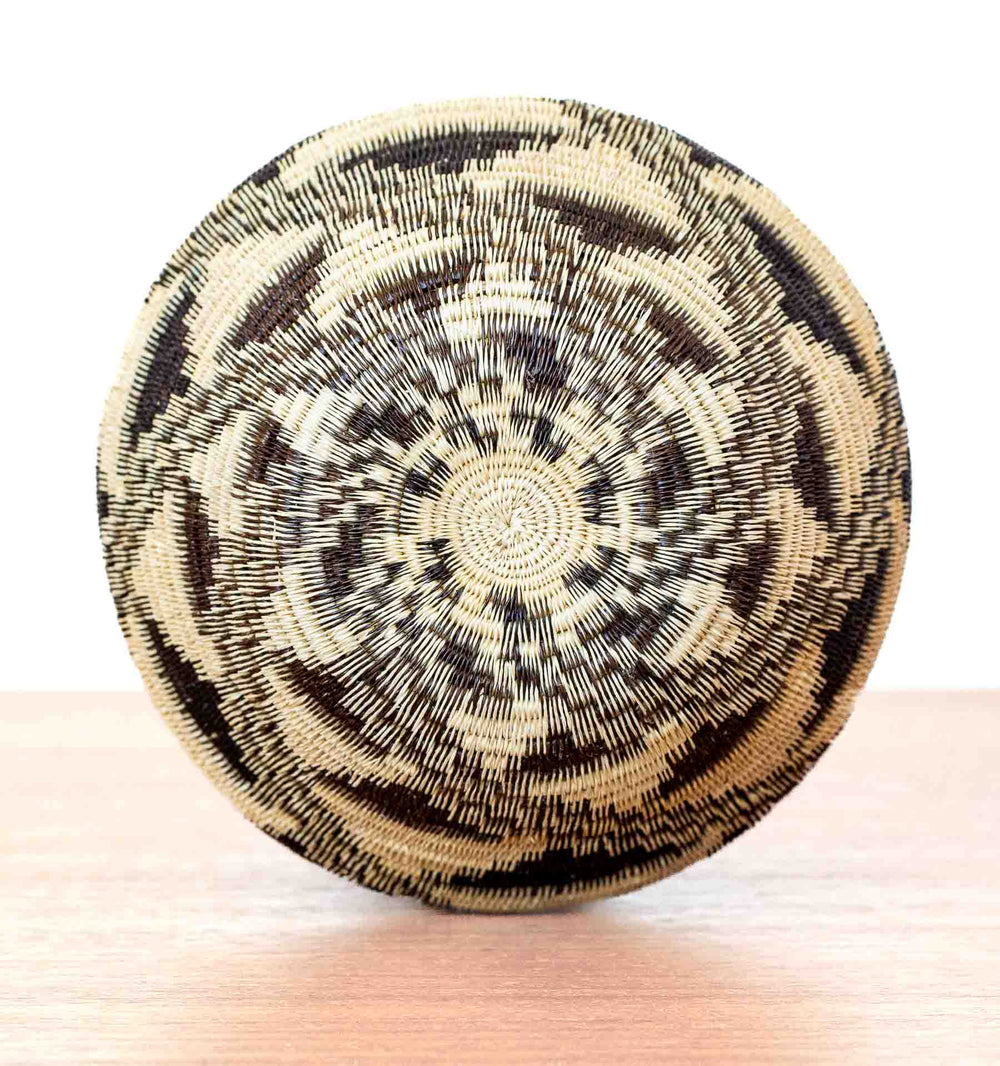 Overhead view of Wounaan woven basket with circular stepped diamond motif in natural palm fiber